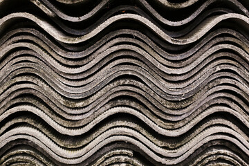 abstract grey background of waving lines, stack of uneven roofing slates.