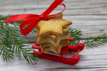 gingerbread cookie and fir tree  red decorative sleds decoration on vintage rustic wooden background. Christmas background. New Year theme. Holidays greeting card