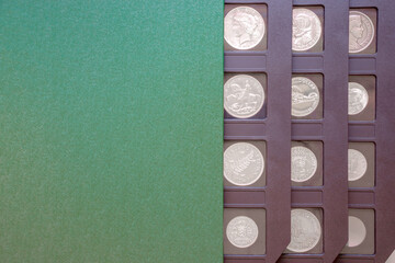 Numismatic album with antique coins collection. Green numismatic case with copy space