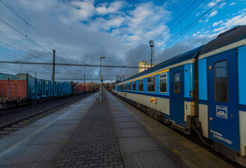 Fototapeta premium Blue electric engine with fast expres train in Plana station in cold winter day