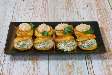 puff pastry-filled appetizer with salad filling on a plate. close up