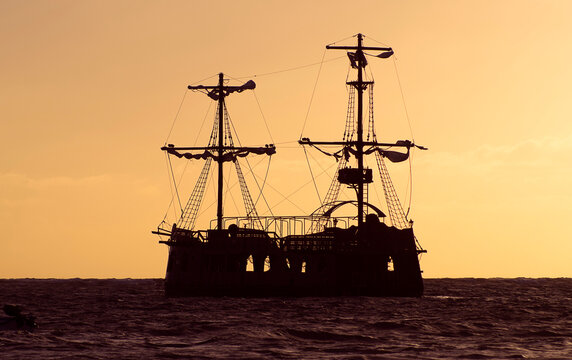 Old style ship silhouette at golden sunset in the Caribbean, Punta Cana, Dominican Republic © felipecamps