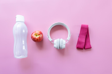 Sports equipment items on pink background, flat lay.