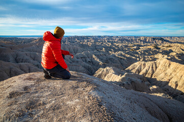 Hiker Takes in Views at Badlands National Park in South Dakota