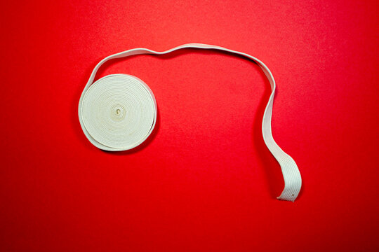 Elastic band for sewing on a red background