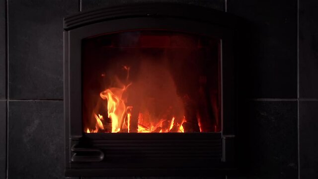 Logs burning in a wood stove. Slow Motion.