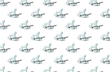 Pattern of handmade wooden toy horse on gray background