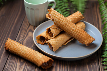 Wafer rolls with condensed milk. Thin and Crispy Waffle. Selective focus