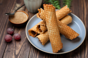 Wafer rolls with condensed milk. Thin and Crispy Waffle. Selective focus