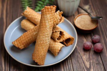 Wafer rolls with condensed milk. Thin and Crispy Waffle. Selective focus