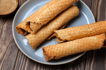 Wafer rolls with condensed milk. Thin and Crispy Waffle. Selective focus