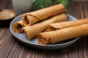 Wafer rolls with condensed milk. Thin and Crispy Waffle. Selective focus