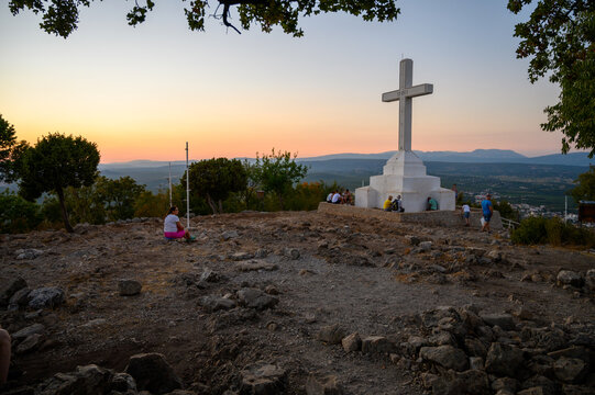 Medjugorje, Bosnia and Herzegovina. 2021-08-18. The white Cross on the top of Krizevac (Cross Mountain) in Medjugorje. (Words on the cross read: "to Jesus Christ, the Redeemer of the human race...")