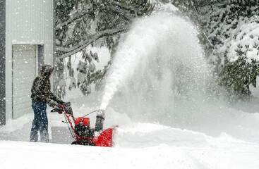 Blowing snow and clearing a path during winter