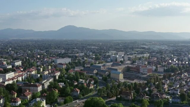 Aerial view Ljubljana Slovenia. Cityscape with houses and streets and on the background of mountain ranges and sunset.