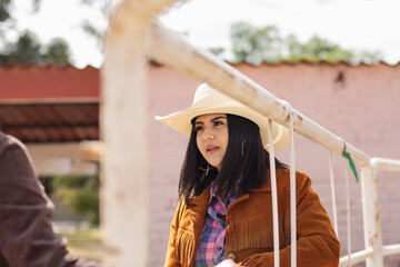 Obraz premium Portrait of a young cowgirl in a ranch