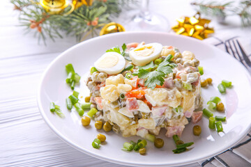 Traditional Russian salad Olivier for Christmas and New Year on a white background. Close up view