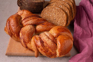 there are different types of bread on a wooden board