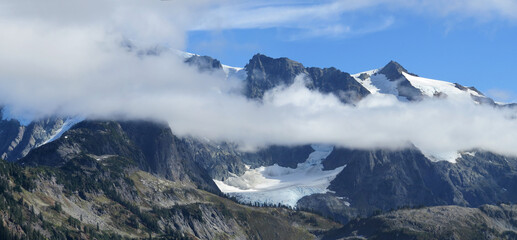 Fototapeta na wymiar Mount Shuksan hiding behind white clouds
