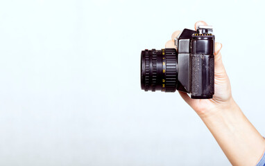 Close-up camera in hand, on white background