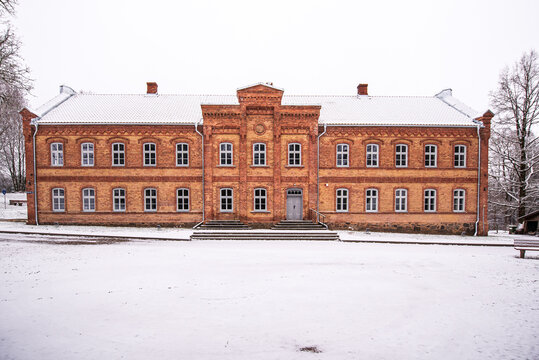 Old Red Brick School In Snowy Winter Day, Vecumnieki, Latvia