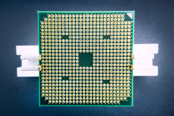 Cpu microprocessor cpu of a computer or laptop close-up. Semiconductors, pins and connectors. Gold-colored contacts on the processor. Closeup