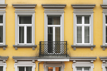 Balcony and facade of a yellow house for the background. Close-up