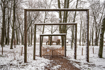 An interesting gate with lights on a winter day leading to the park, Kurmene, Latvia