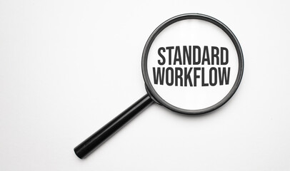 Magnifying glass with the word Standard workflow on chart background