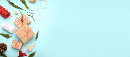 Composition with Christmas gifts on blue background with space for text