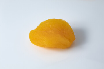 Ripe and dry Turkish apricot fruit, seedless on white background.