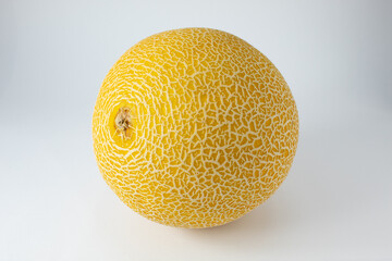 Ripe and whole Gaul melon. Tropical fruit with white streaks on the yellow skin