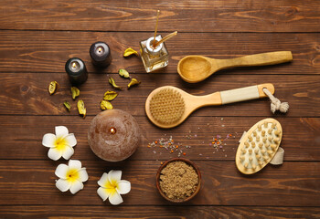 Beautiful spa composition with burning candles and flowers on wooden background