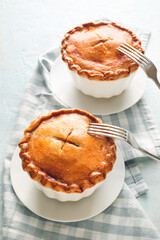 Tasty beef pot pies on light background © Pixel-Shot