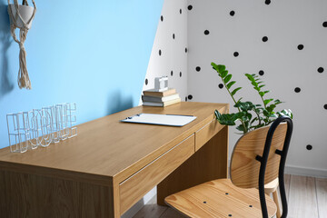 Work HOME, clipboard and books on wooden table near color wall