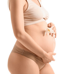 Beautiful pregnant woman with orchid flower on white background