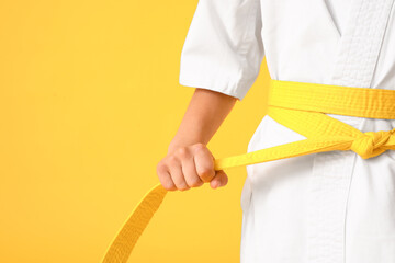 Little boy in karategi on color background, closeup