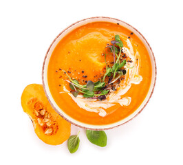 Bowl with delicious pumpkin cream soup on white background