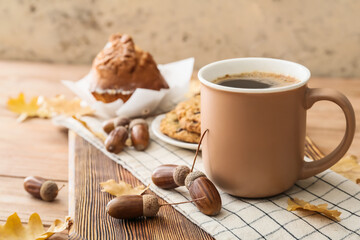 Cup of coffee with acorns and autumn leaves on table © Pixel-Shot