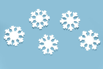 Beautiful paper snowflakes on blue background