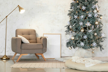 Interior of light room with Christmas tree, armchair and floor lamp