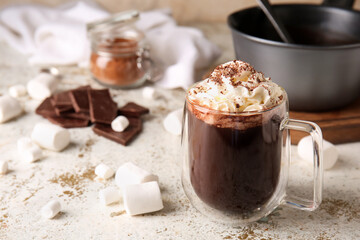 Glass cup of tasty hot chocolate on light background
