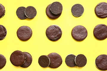 Naklejka premium Tasty chocolate cookies with cream on yellow background