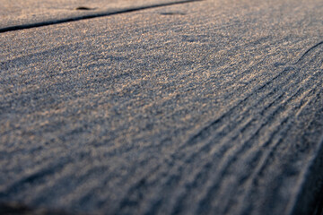 close up of frost on a wooden table
