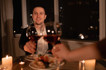 dinner valentines day, couple hands with glass of wine, evening of love at home together, date after work, wedding anniversary dine with alcohol