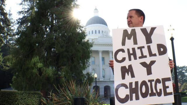 Male Political Protester with My Child My Choice Sign