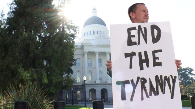 Male Political Protester with End the Tyranny Sign