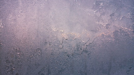 Frost texture on the window glass in winter. Ice Crystals in Winter Blue and Pink.