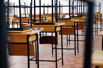 Desk and chairs in classroom at school 