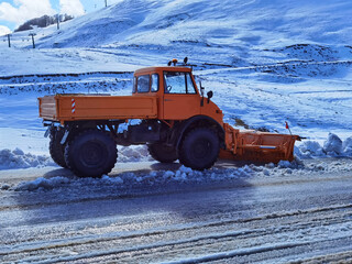 snowplough shovel machin cleaning the road from snow and  ice in winter